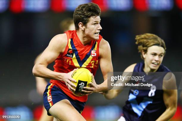 Jacob Collins of South Australia runs with the ball during the U18 AFL Championship match between Vic Metro and South Australia at Etihad Stadium on...