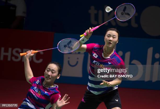 So Hee Lee and Seung Chan Shin of South Korea hit a return against Stefani Stovea and Gabriella Stovea of Bulgaria during their women's doubles...