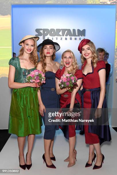 Silvia Schneider poses with models at the Sportalm Kitzbuehel show during the Berlin Fashion Week Spring/Summer 2019 at ewerk on July 4, 2018 in...