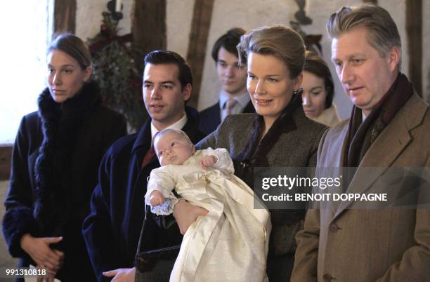 Prince Philippe and Princess Mathilde hold their son Prince Emmanuel during his baptism, 10 December 2005 at the chapel of the Castle of Ciergnon....