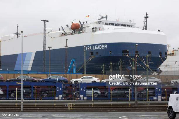 Passenger car export overseas at BLG Logistics in Bremerhaven. The picture shows a car transport train in front of a car transport vessel.