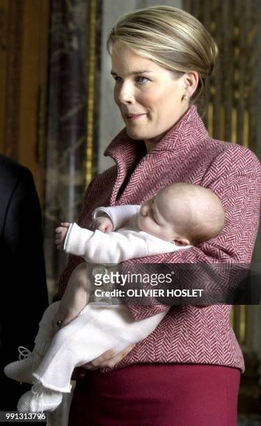 Belgium's Princess Mathilde holds her first child Princess Elisabeth in her arms, 08 January 2002, as the Belgian Royal Family poses for a family...
