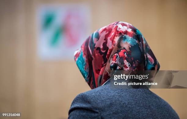 Representative of the council of Muslims stands in front of the federal coat of arms in the higher administrative court in Muenster, Germany, 9...