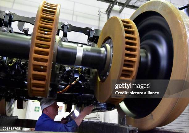 Staff member works on the final assembly of a pivoted bogie at the metal construction company TransTec F&E Vetschau GmbH in Vetschau, Germany, 9...