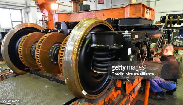 Staff member works on the final assembly of a pivoted bogie at the metal construction company TransTec F&E Vetschau GmbH in Vetschau, Germany, 9...