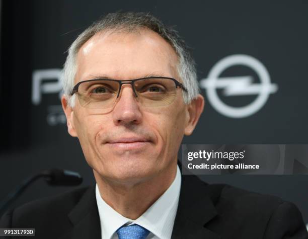 The chairman of PSA Peugeot Citroen Carlos Tavares looks on the crowd during the press conference at the Opel Design Centre in Ruesselsheim, Germany,...