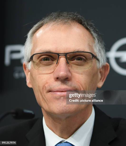 The chairman of PSA Peugeot Citroen Carlos Tavares looks on the crowd during the press conference at the Opel Design Centre in Ruesselsheim, Germany,...