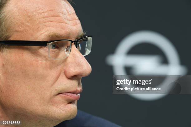 Michael Lohscheller, Opel Automobile's CEO, with the company's logo in the background while looking on the crowd during a press conference at the...