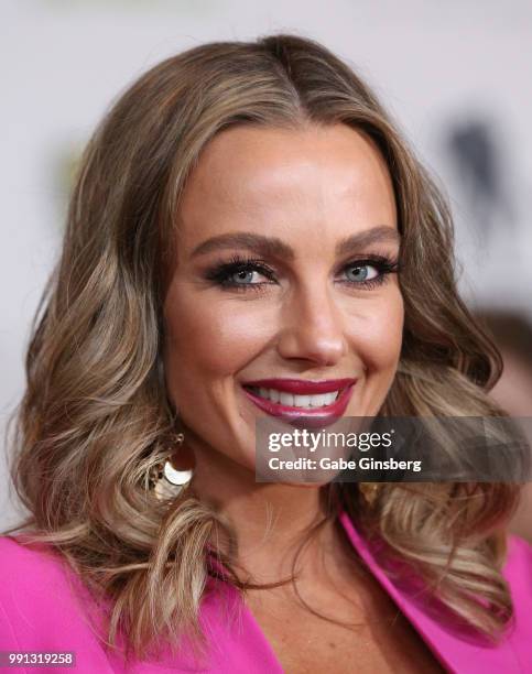 Television personality Amber Nichole Miller speaks to an interviewer during the 10th annual Fighters Only World Mixed Martial Arts Awards at Palms...