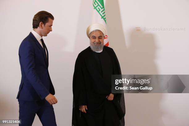 Austrian Chancellor Sebastian Kurz and Iranian President Hassan Rouhani arrive for a brief media opportunity at the Federak Chancellery on July 4,...