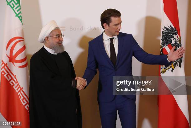 Austrian Chancellor Sebastian Kurz and Iranian President Hassan Rouhani arrive for a brief media opportunity at the Federak Chancellery on July 4,...