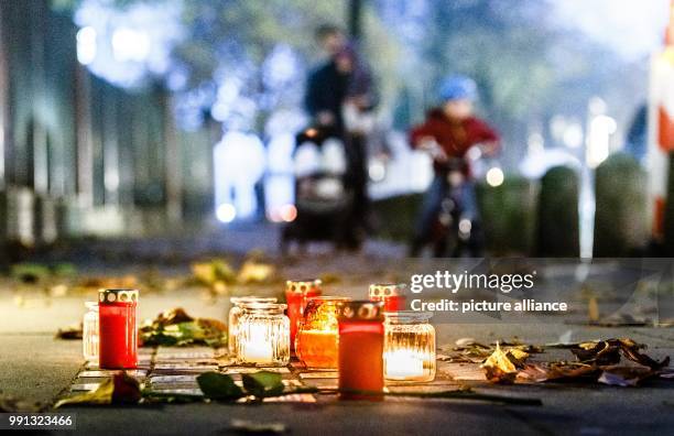 Residents have lit candles on so-called 'stumbling stones', which remember the deportation and murdering of jews in the Third Reich, in Hamburg,...