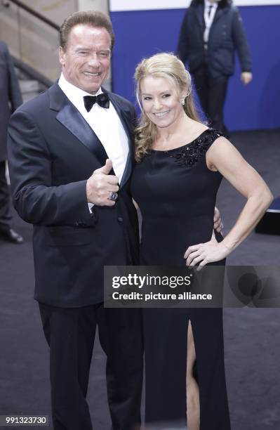 Arnold Schwarzenegger and Heather Milligan arrive at the 'GQ Men of the Year 2017' gala at the Komische Oper in Berlin, Germany, 9 November 2017....