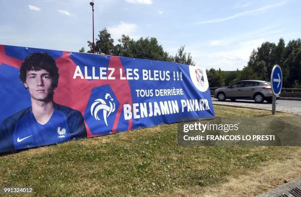 Car drives past a banner supporting home-grown French footballer right-back defender Benjamin Pavard who is a local of the town of Jeumont, and...