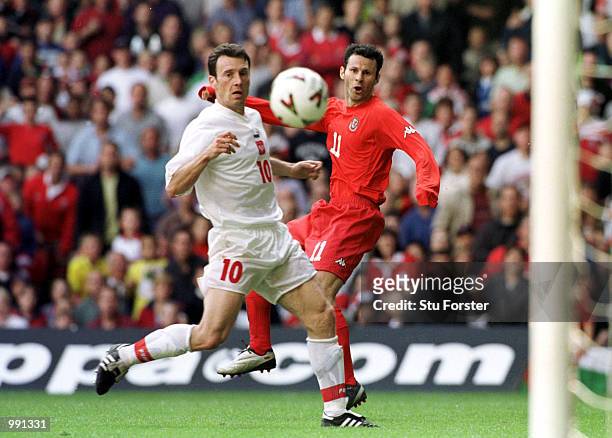 Ryan Giggs of Wales hits the ball past Tomasz Zdebel of Poland during the match between Wales and Poland in the 2002 World Cup Qualifying Group 5 at...