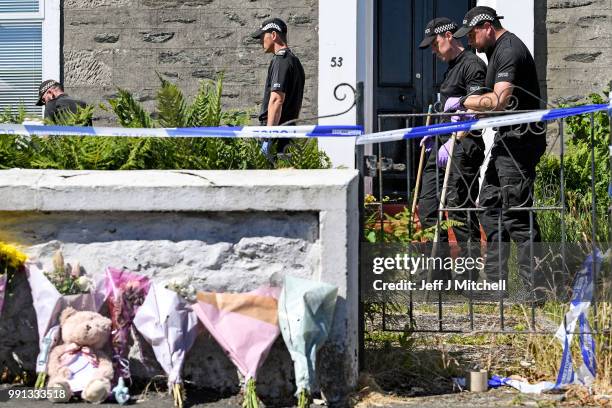 Police forensic officers search a garden at a house on Ardbeg Road on the Isle of Bute following the conformation that six year old schoolgirl Alesha...