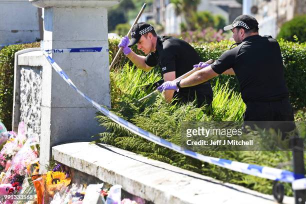 Police forensic officers search a garden at a house on Ardbeg Road on the Isle of Bute following the conformation that six year old schoolgirl Alesha...