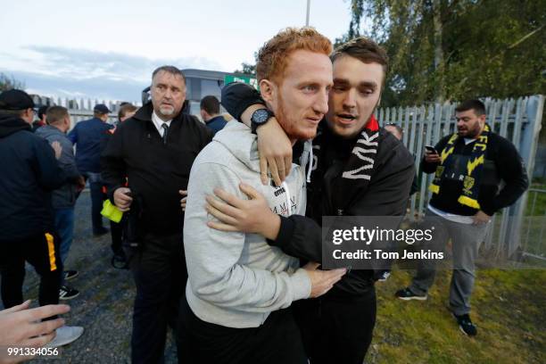 Dons club captain Dean Lewington is hugged and encouraged by away fans as he gets off the team coach before the AFC Wimbledon v MK Dons League One...