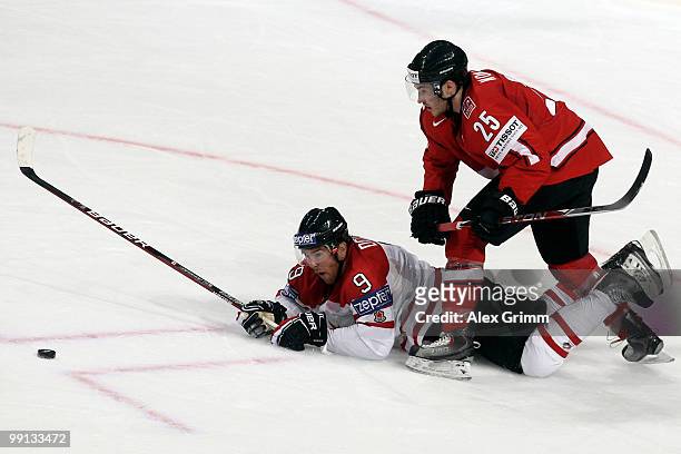 Steve Downie of Canada is challenged by Thibaut Monnet of Switzerland during the IIHF World Championship group C match between Canada and Switzerland...