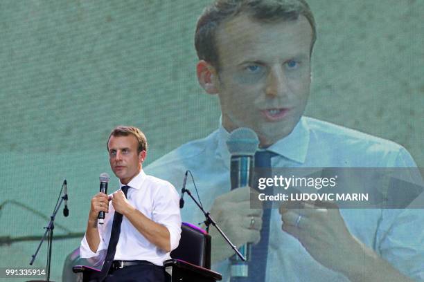 French President Emmanuel Macron answers questions during a live interview on Trace tv in the Afrika Shrine in Lagos on July 3, 2018. - French...