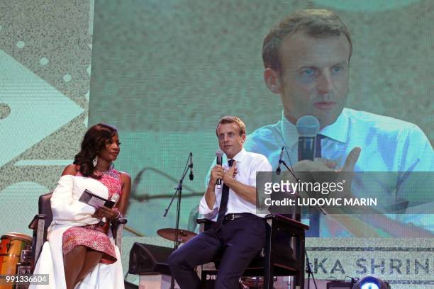 French President Emmanuel Macron answers questions during a live interview on Trace tv in the Afrika Shrine in Lagos on July 3, 2018. - French...