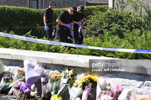 Police forensic officers search a garden at a house on Ardbeg Road on the Isle of Bute following the conformation that six year old schoolgirl Alesha...