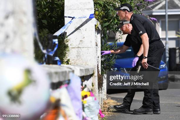 Police forensic officers search a garden at a house on Ardbeg Road on the Isle of Bute following the conformation that six year old schoolgirl Alesha...