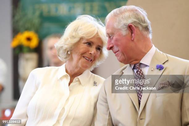 Prince Charles, Prince of Wales and Camilla, Duchess of Cornwall look at eachother as they reopen the newly-renovated Edwardian community hall The...