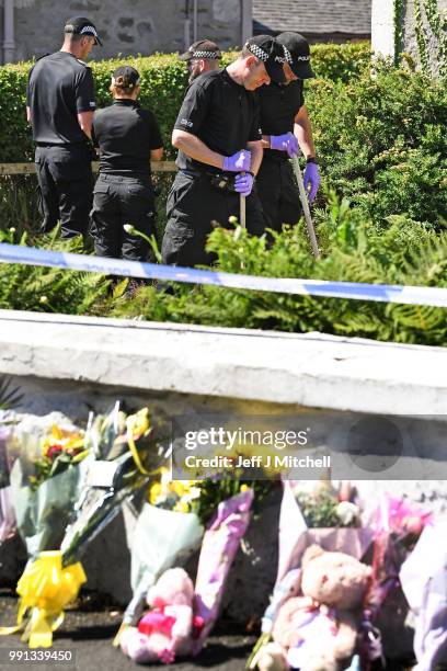 Police forensic officers search a garden at a house on Ardbeg Road on the Isle of Bute following the conformation that six year old schoolgirl Alesha...