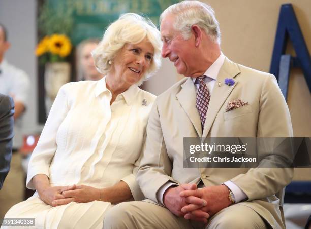 Prince Charles, Prince of Wales and Camilla, Duchess of Cornwall look at eachother as they reopen the newly-renovated Edwardian community hall The...