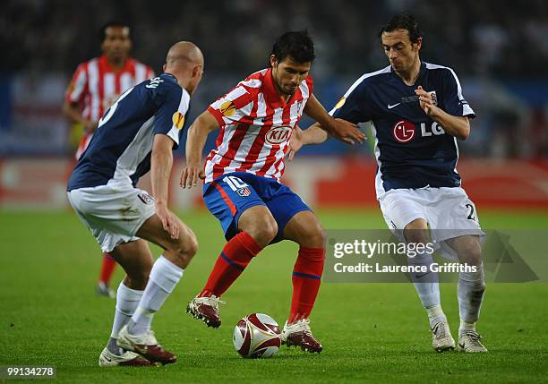 Sergio Aguero of Atletico Madrid is challenged by Simon Davies and Paul Konchesky of Fulham during the UEFA Europa League final match between...