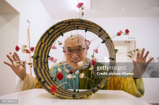 The Japanese Fluxus-artist Takako Saito, who is currently living in Duesseldorf, looks through a "Roehrenschachspiel" during a press conference...