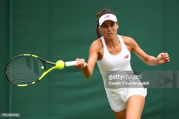 Sorana Cirstea of Romania returns against Evgeniya Rodina of Russia during her Ladies' Singles second round match on day three of the Wimbledon Lawn...