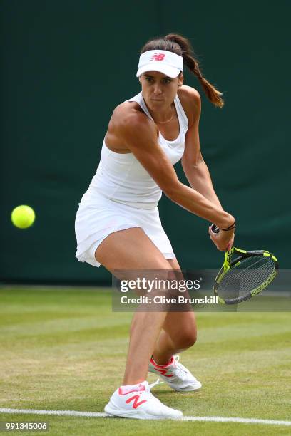 Sorana Cirstea of Romania returns against Evgeniya Rodina of Russia during her Ladies' Singles second round match on day three of the Wimbledon Lawn...