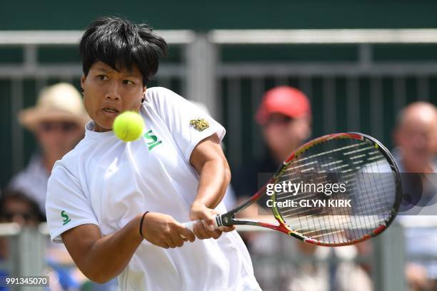 Thailand's Luksika Kumkhum returns to US player Madison Keys during their women's singles second round match on the third day of the 2018 Wimbledon...