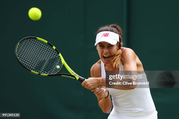 Sorana Cirstea of Romania returns against Evgeniya Rodina of Russia during her Ladies' Singles second round match on day three of the Wimbledon Lawn...