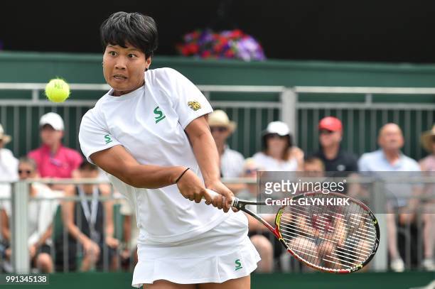 Thailand's Luksika Kumkhum returns to US player Madison Keys during their women's singles second round match on the third day of the 2018 Wimbledon...