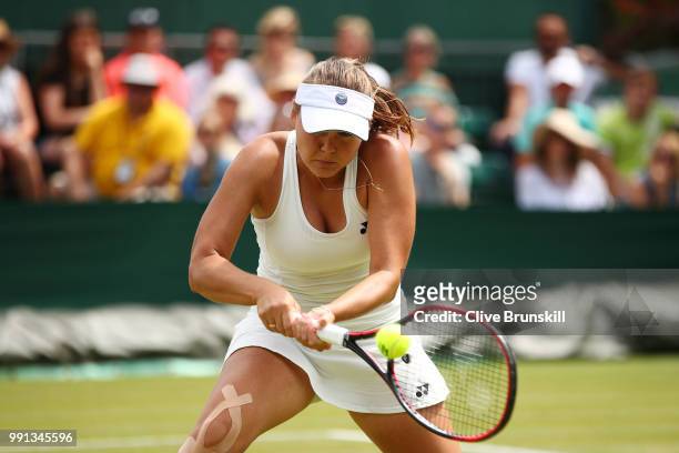 Evgeniya Rodina of Russia returns against Sorana Cirstea of Romania during their Ladies' Singles second round match on day three of the Wimbledon...
