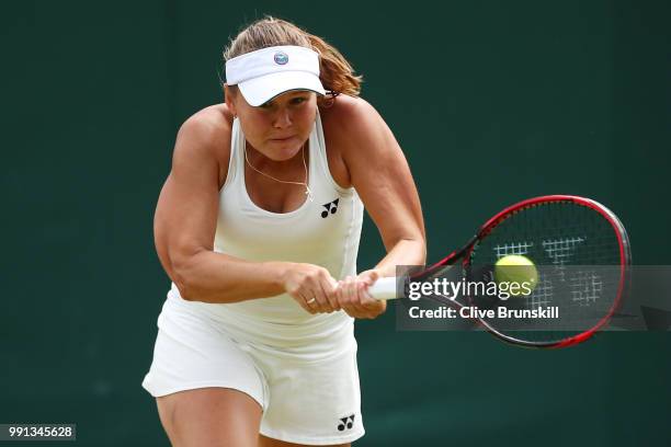 Evgeniya Rodina of Russia returns against Sorana Cirstea of Romania during their Ladies' Singles second round match on day three of the Wimbledon...