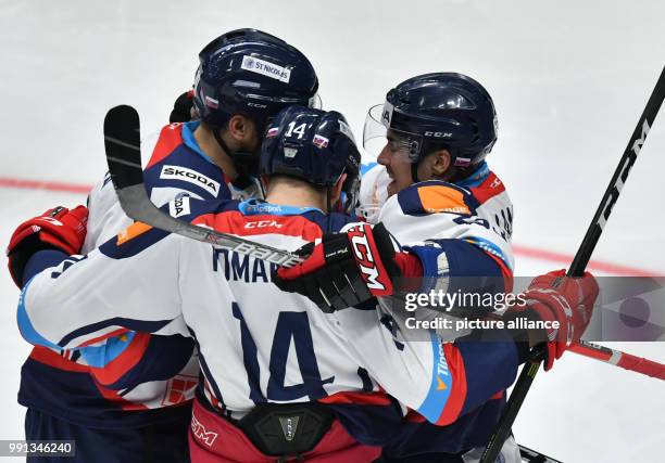 Slovakia's Tomas Marcinko , Ladislav Romancik and Patrik Lamper celebrate Lamper's 1-0 goal during the Ice hockey Deutschland Cup match between...