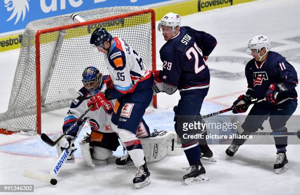 Ryan Stoa and USA's Ryan Lasch in action against Slovakia's goalkeeper Jan Laco and Michal Cajkovsky during the Ice hockey Deutschland Cup match...