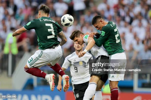 Carlos Salcedo of Mexico Mario Gomez of Germany Hirving Lozano of Mexico during the 2018 FIFA World Cup Russia group F match between Germany and...