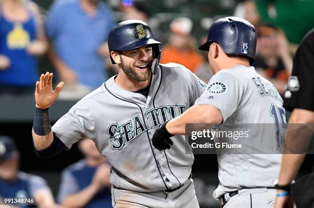 Kyle Seager of the Seattle Mariners celebrates with Mitch Haniger after hitting a two-run home run in the ninth inning against the Baltimore Orioles...