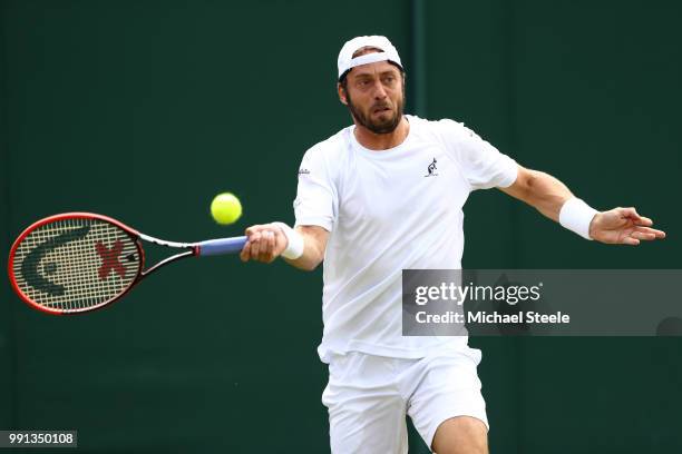 Paolo Lorenzi of Italy returns against Gael Monfils of France during their Men's Singles second round match on day three of the Wimbledon Lawn Tennis...