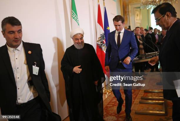 Austrian Chancellor Sebastian Kurz and Iranian President Hassan Rouhani depart after speaking to the media following talks at the Federal Chancellery...