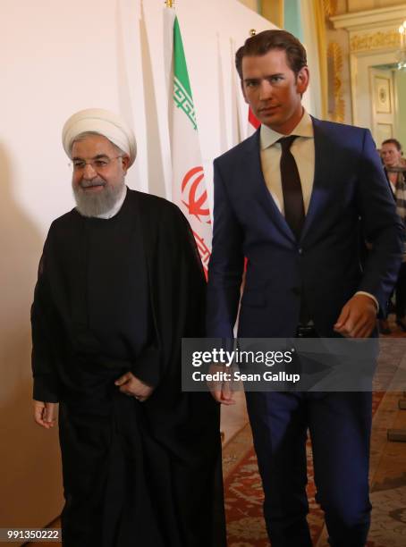 Austrian Chancellor Sebastian Kurz and Iranian President Hassan Rouhani depart after speaking to the media following talks at the Federal Chancellery...