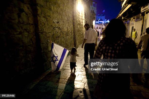 Girl waves a flag as Israelis take part in a march marking Jerusalem Day on May 12, 2010. Israel is celebrating the anniversary of the 'unification'...