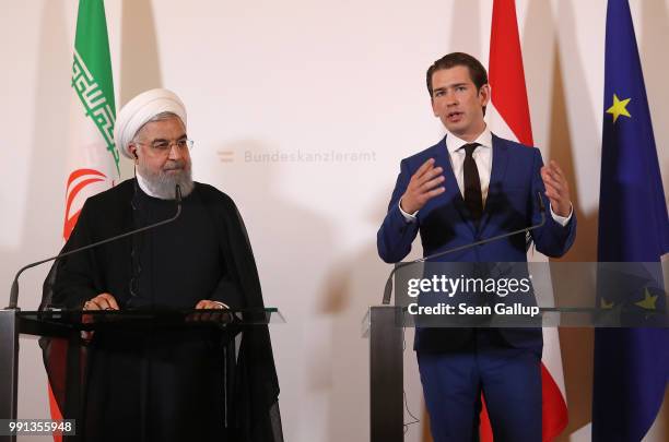 Austrian Chancellor Sebastian Kurz and Iranian President Hassan Rouhani speak to the media following talks at the Federal Chancellery on July 4, 2018...