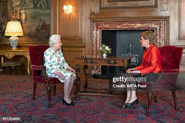 Queen Elizabeth II meets with Scotland's First Minister Nicola Sturgeon during a private audience at the Palace of Holyrood House on July 4, 2018 in...