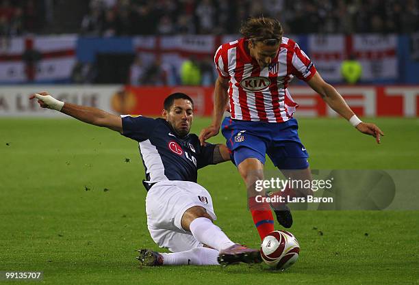 Clint Dempsey of Fulham challenges Diego Forlan of Madrid during the UEFA Europa League final match between Atletico Madrid and Fulham at HSH...